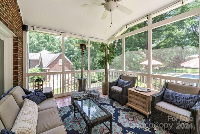 sunroom / solarium featuring ceiling fan and a wealth of natural light