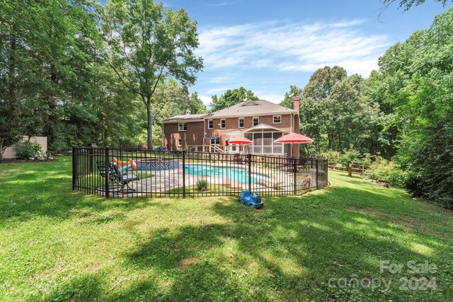 view of swimming pool featuring a lawn and a patio