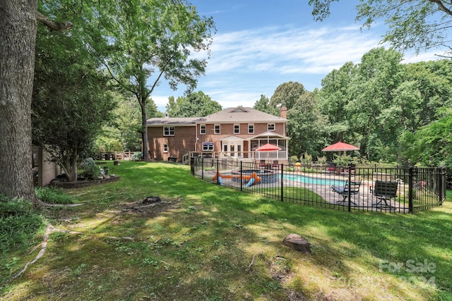 view of yard with a fenced in pool and a patio