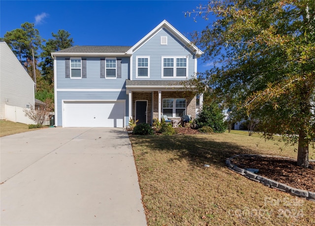 view of front of house featuring a front yard and a garage