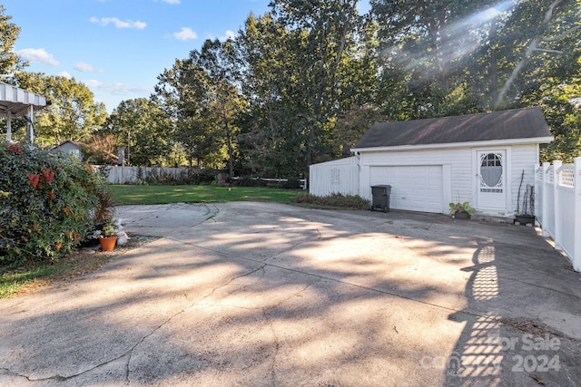 view of patio / terrace featuring an outdoor structure and a garage