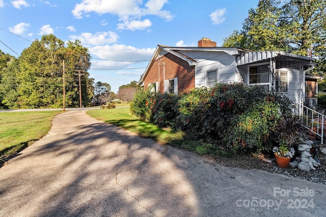 view of property exterior with a yard