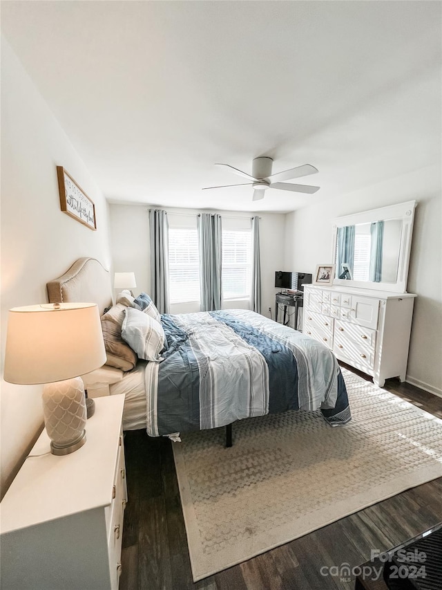 bedroom with ceiling fan and dark hardwood / wood-style floors