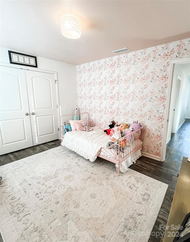 bedroom with dark hardwood / wood-style flooring