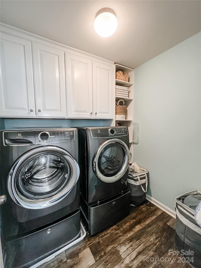 laundry area with cabinets, separate washer and dryer, and dark wood-type flooring