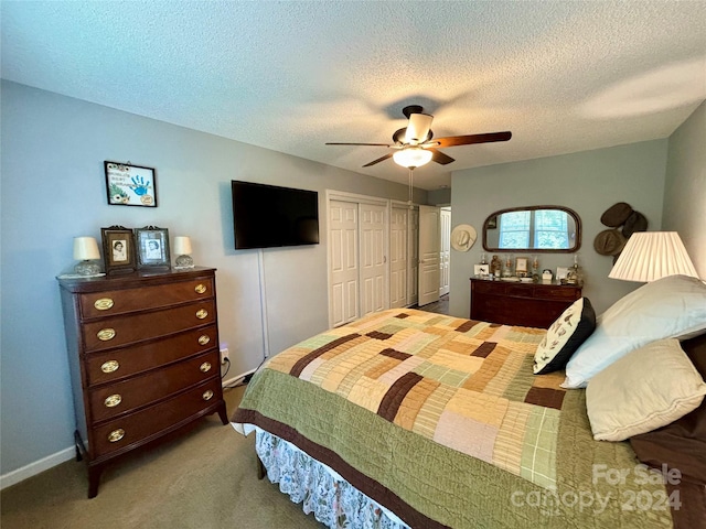 carpeted bedroom featuring a closet, a textured ceiling, and ceiling fan