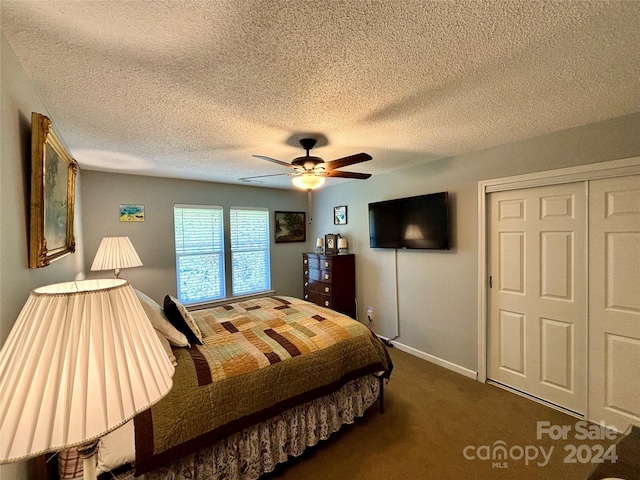 bedroom with a closet, ceiling fan, a textured ceiling, and dark colored carpet