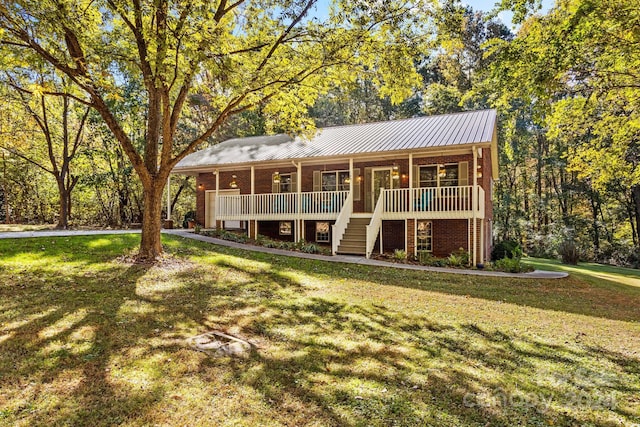 view of front of house with a front yard and a wooden deck