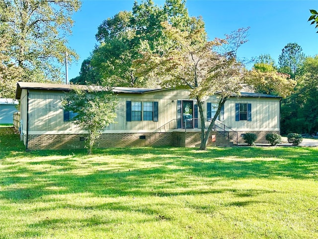 manufactured / mobile home featuring a front lawn and crawl space