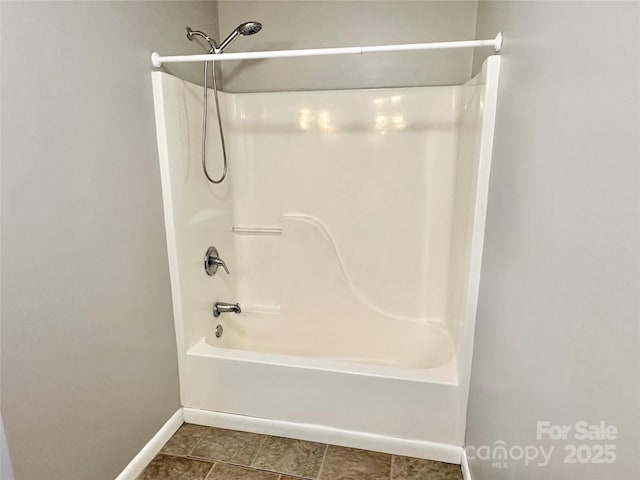 full bath featuring shower / tub combination and baseboards