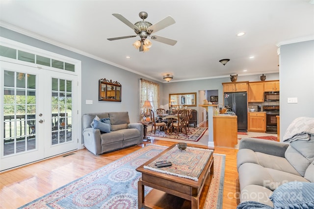 living room with french doors, light wood-type flooring, ornamental molding, and ceiling fan