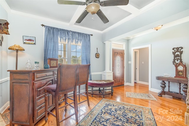 office area featuring ceiling fan, coffered ceiling, light hardwood / wood-style flooring, beam ceiling, and decorative columns