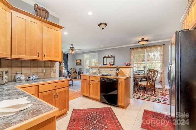 kitchen featuring black appliances, plenty of natural light, crown molding, and backsplash