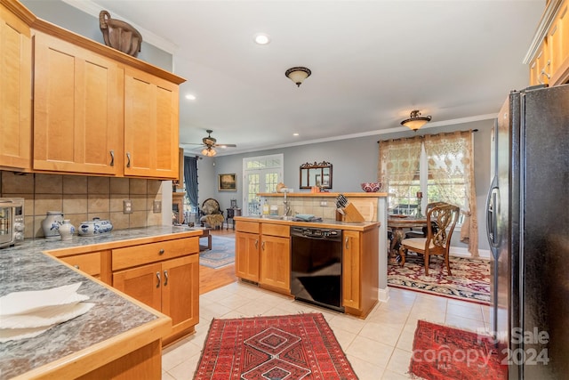 kitchen featuring light tile patterned flooring, a wealth of natural light, backsplash, and black appliances