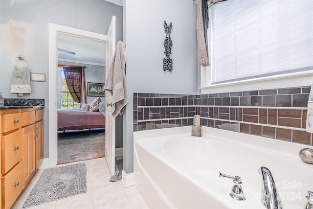 bathroom featuring a bathtub, tile patterned flooring, and vanity