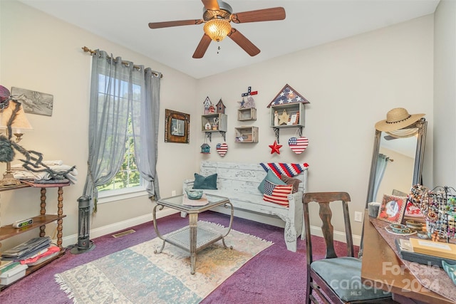 living area with carpet flooring and ceiling fan