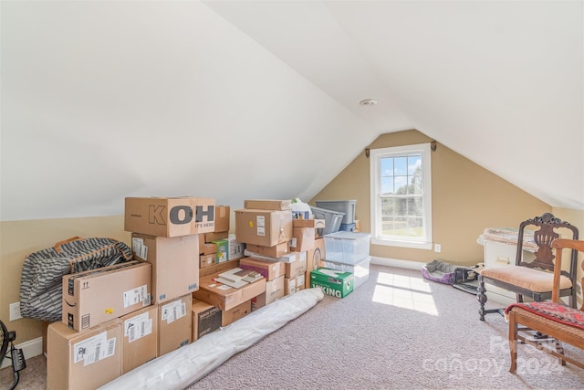 interior space with vaulted ceiling and carpet flooring