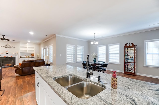 kitchen featuring white cabinetry, light stone counters, and a wealth of natural light