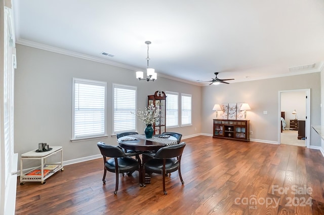 dining area featuring ornamental molding, dark hardwood / wood-style floors, and ceiling fan with notable chandelier