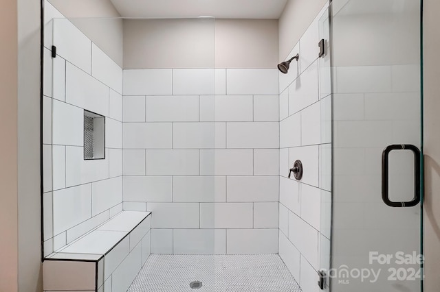 bathroom with a shower with shower door