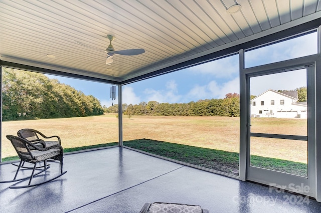 unfurnished sunroom with wooden ceiling and ceiling fan