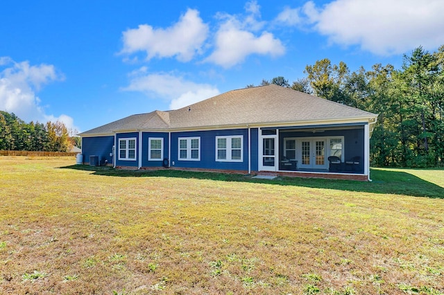 rear view of house with a yard and cooling unit