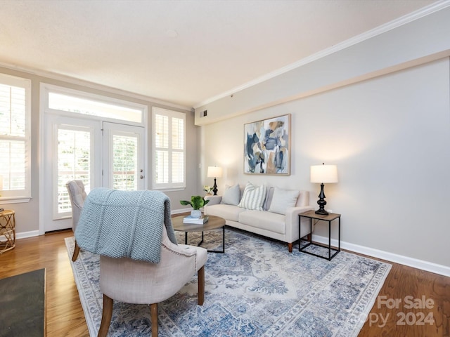 living room featuring crown molding and hardwood / wood-style flooring