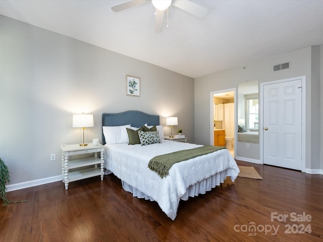 bedroom with ceiling fan, dark hardwood / wood-style flooring, and ensuite bath