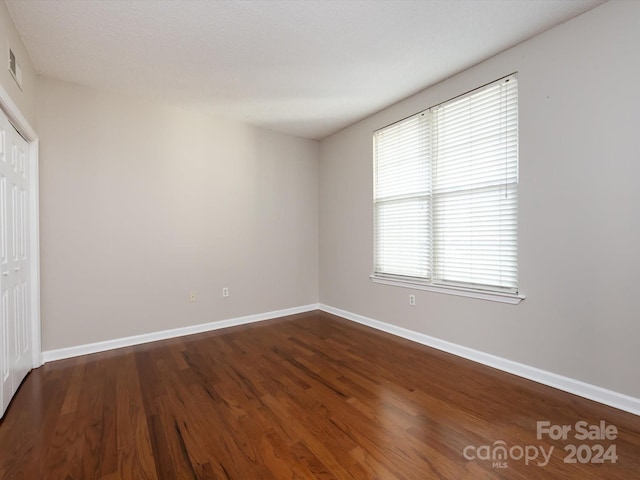 empty room with wood-type flooring