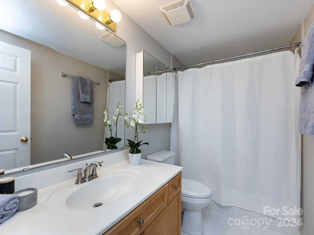 bathroom featuring vanity, curtained shower, toilet, and tile patterned floors