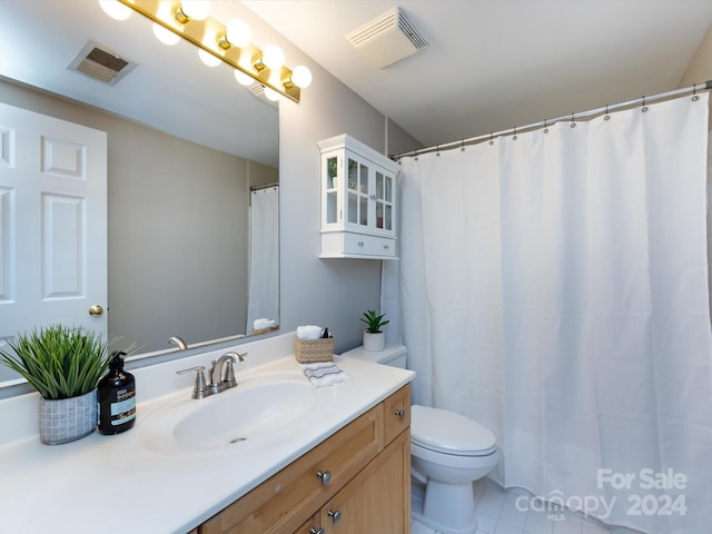 bathroom with vanity, toilet, and tile patterned flooring