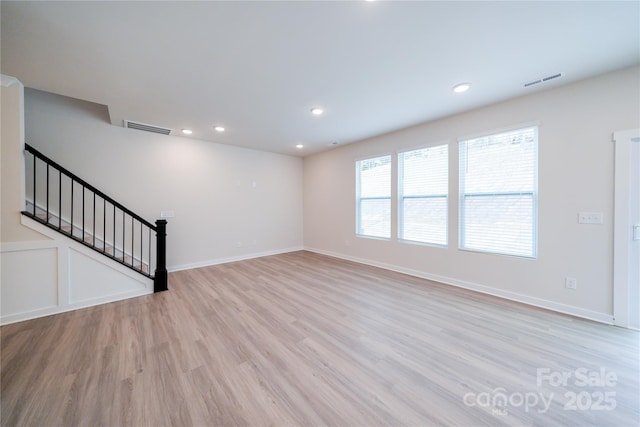 unfurnished living room with light hardwood / wood-style flooring