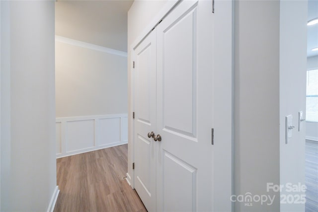 corridor with light wood-type flooring