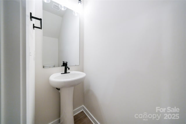 bathroom with hardwood / wood-style flooring