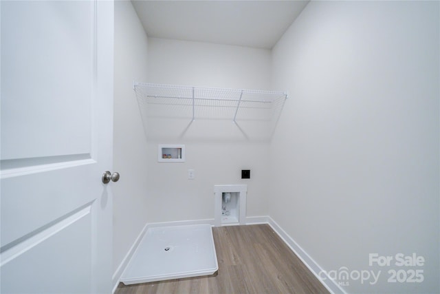 washroom featuring electric dryer hookup, hookup for a washing machine, and light hardwood / wood-style floors