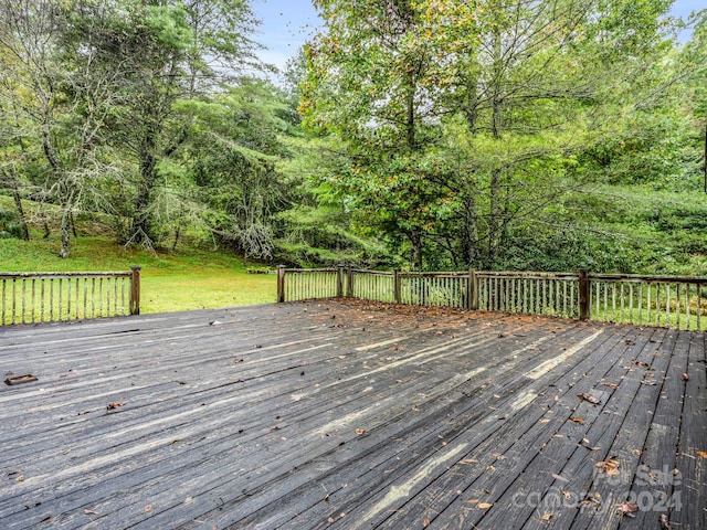 wooden terrace with a yard