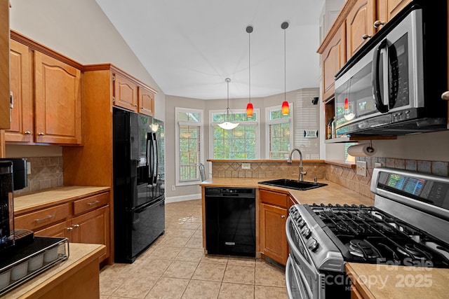 kitchen with black appliances, sink, hanging light fixtures, decorative backsplash, and light tile patterned floors