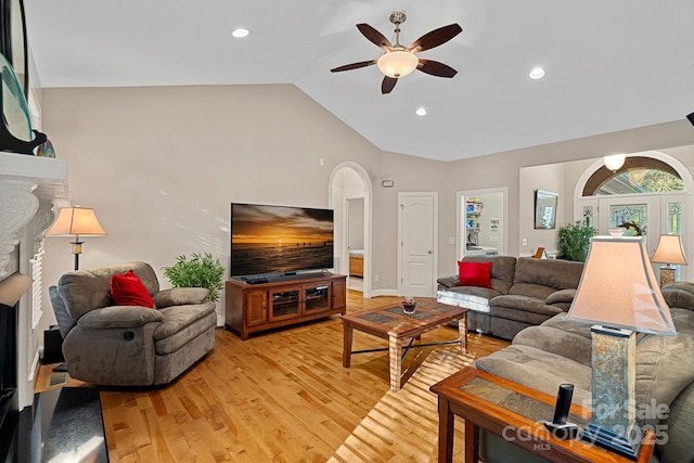 living room with high vaulted ceiling, light hardwood / wood-style flooring, and ceiling fan