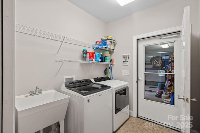 washroom featuring washing machine and dryer and sink