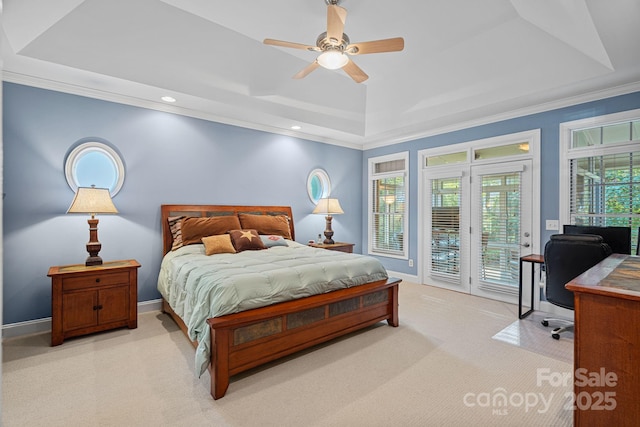 carpeted bedroom featuring access to exterior, a tray ceiling, ceiling fan, and ornamental molding