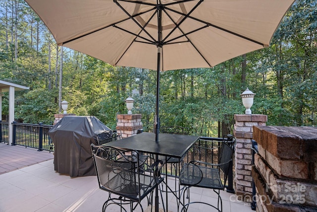 view of patio / terrace with a grill and a fireplace