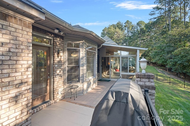 view of patio / terrace featuring a sunroom