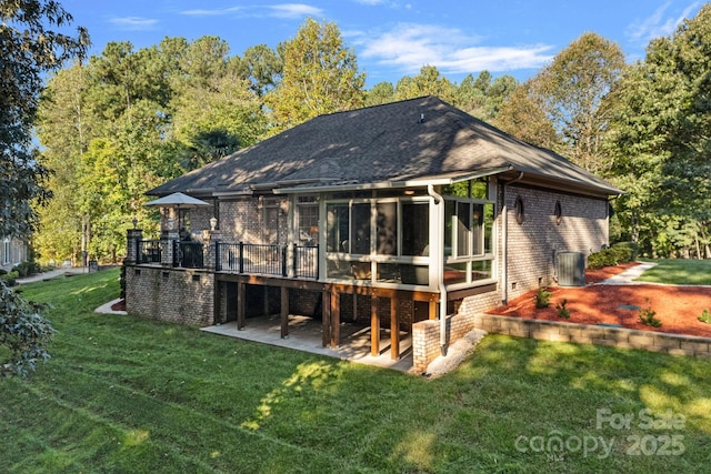 rear view of property with a patio area, a sunroom, a yard, and a deck