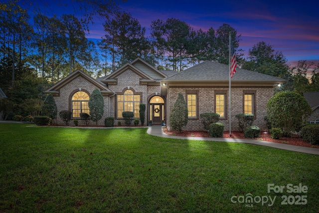 ranch-style home with a yard