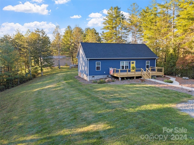 view of front facade featuring a front yard and a deck