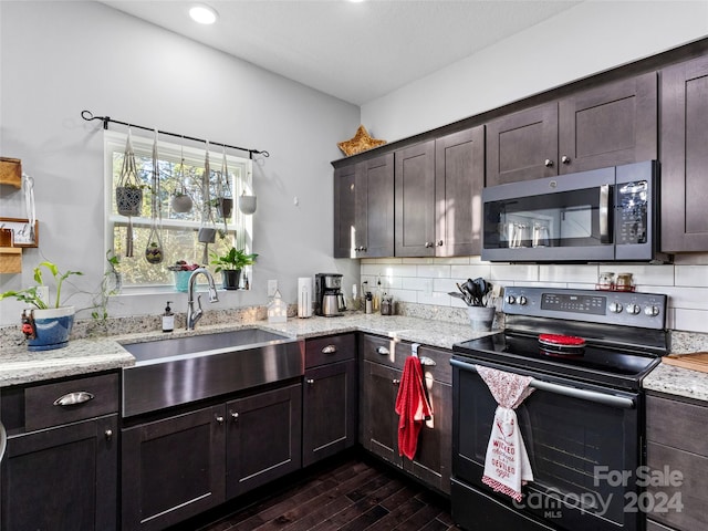 kitchen featuring dark brown cabinetry, black range with electric cooktop, dark hardwood / wood-style flooring, and decorative backsplash