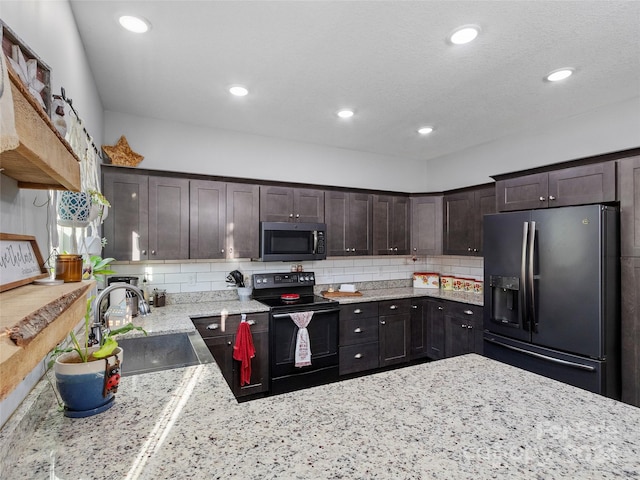 kitchen with tasteful backsplash, appliances with stainless steel finishes, sink, and dark brown cabinetry