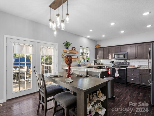 dining space with sink, french doors, and dark hardwood / wood-style flooring