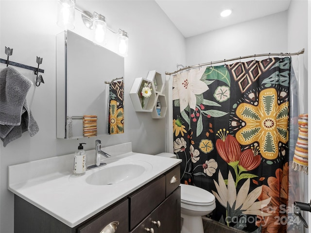 bathroom featuring vanity and toilet