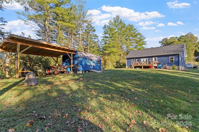 view of yard with a storage shed and a wooden deck